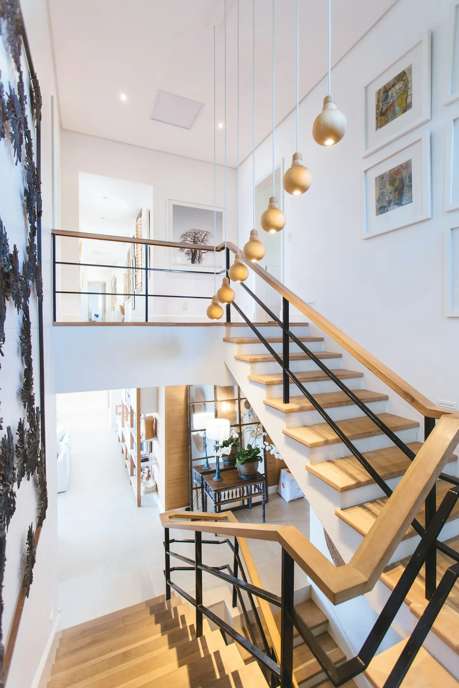Bright modern staircase with timber treads and gallery wall